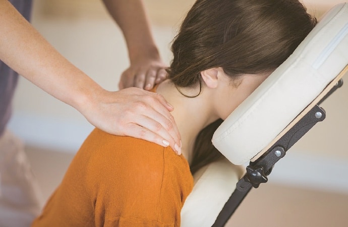 woman receiving a chair massage, Saunders Massage Therapy